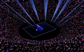 A digital art piece with the numbers '2024' illuminated on a platform at the center. Surrounding the platform, a vast array of multicolored stars and sparkles create a galaxy-like effect. Beams of light shine downwards, enhancing the futuristic and celebratory atmosphere.