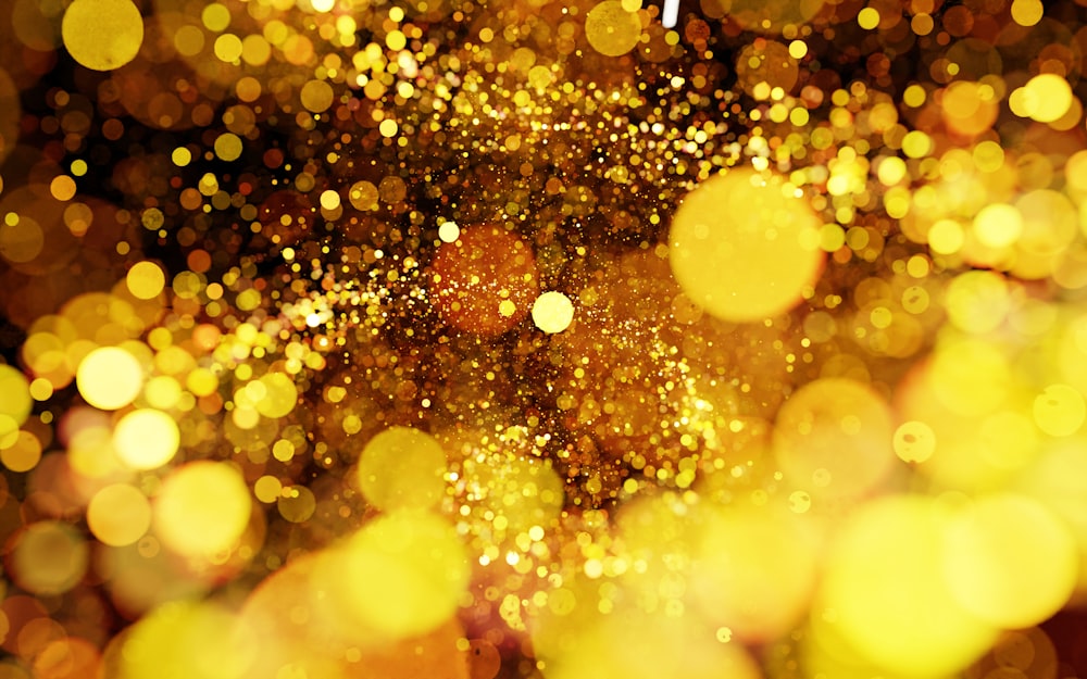 a blurry photo of a gold glitter background
