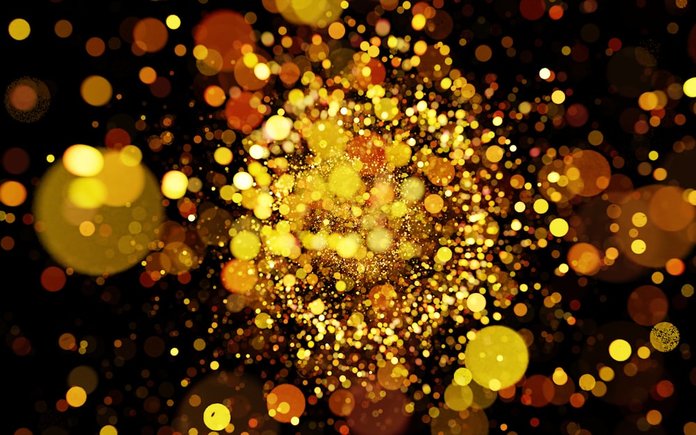 a blurry image of gold lights on a black background