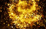 Abstract dark background with shimmering golden light effects symbolizing wealth.