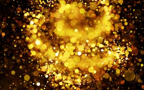 Abstract dark background with shimmering golden light effects symbolizing wealth.