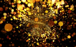 Close-up of sparkling particles merging into a new, radiant form.