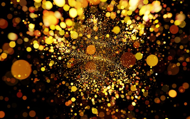 A colorful debt dissolver charm dissolving into golden particles over a dark purple backdrop.