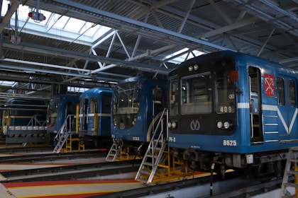 a blue train parked in a train station