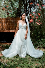 A radiant bride laughing under soft golden sunlight in an outdoor garden.