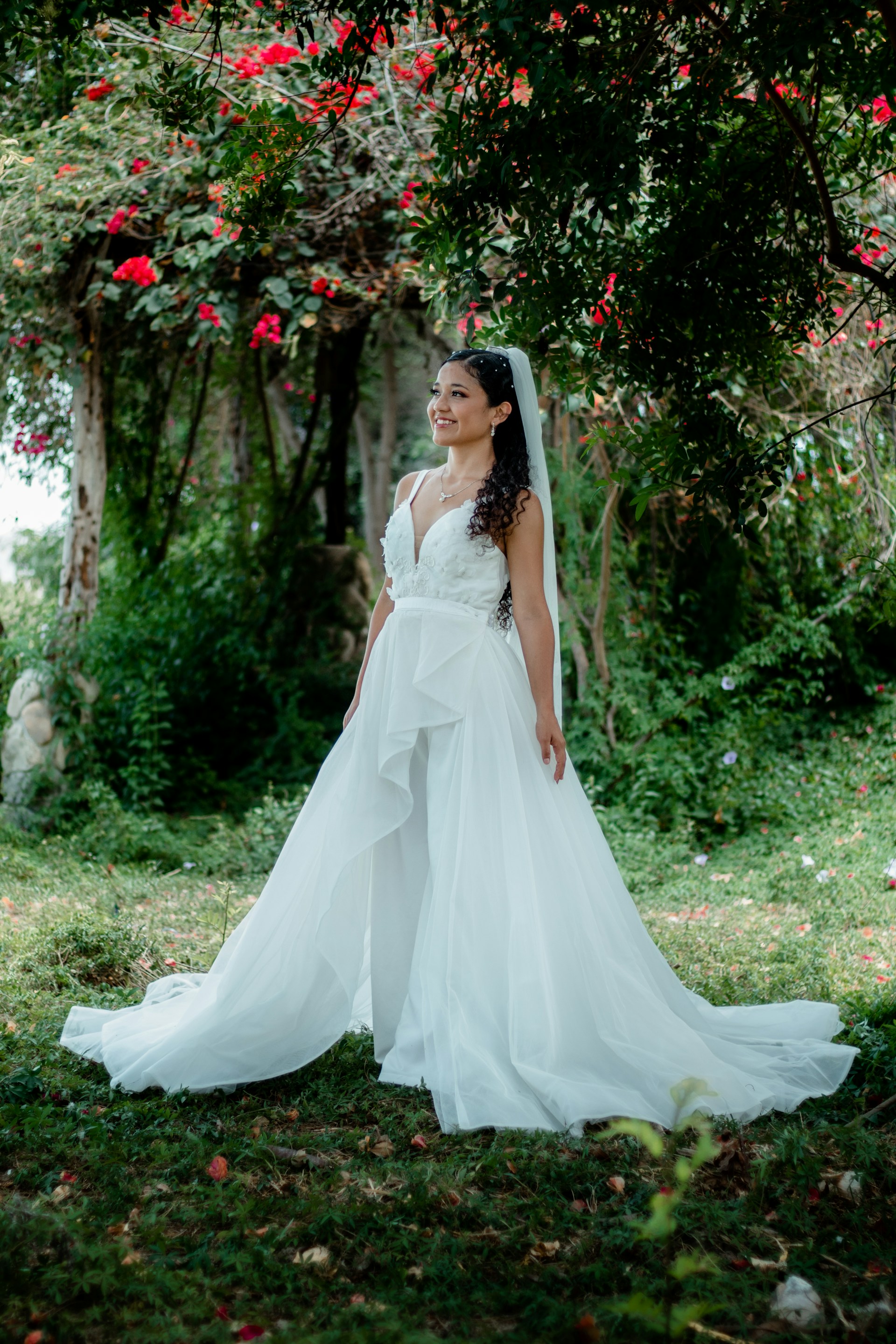 A radiant bride laughing joyfully in a sunlit garden, capturing the magic of a wedding day.