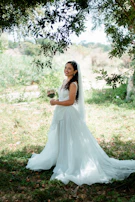 Bride laughing naturally with flowing veil in gentle breeze.