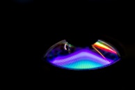 A colorful music waveform visualizer glowing against a dark background.