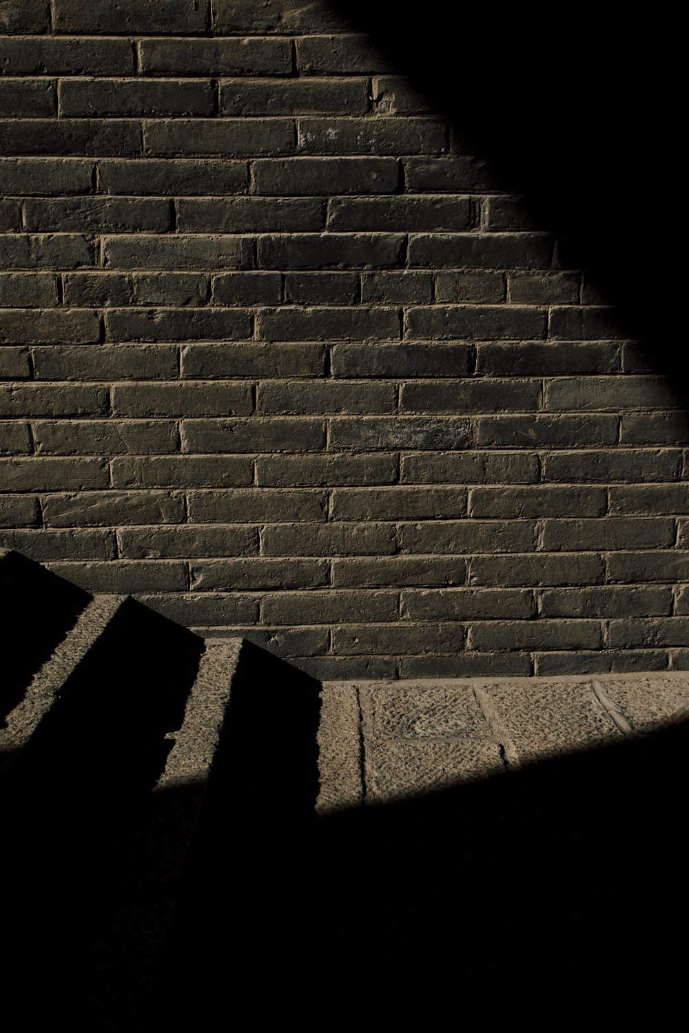 the shadow of a person walking up a flight of stairs