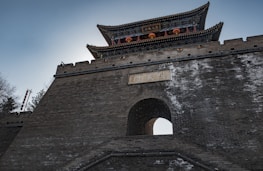 The Great Wall of China illuminated at dusk, symbolizing strength and heritage.