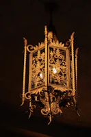 A warm vintage brass chandelier casting a soft glow over a cozy living room.