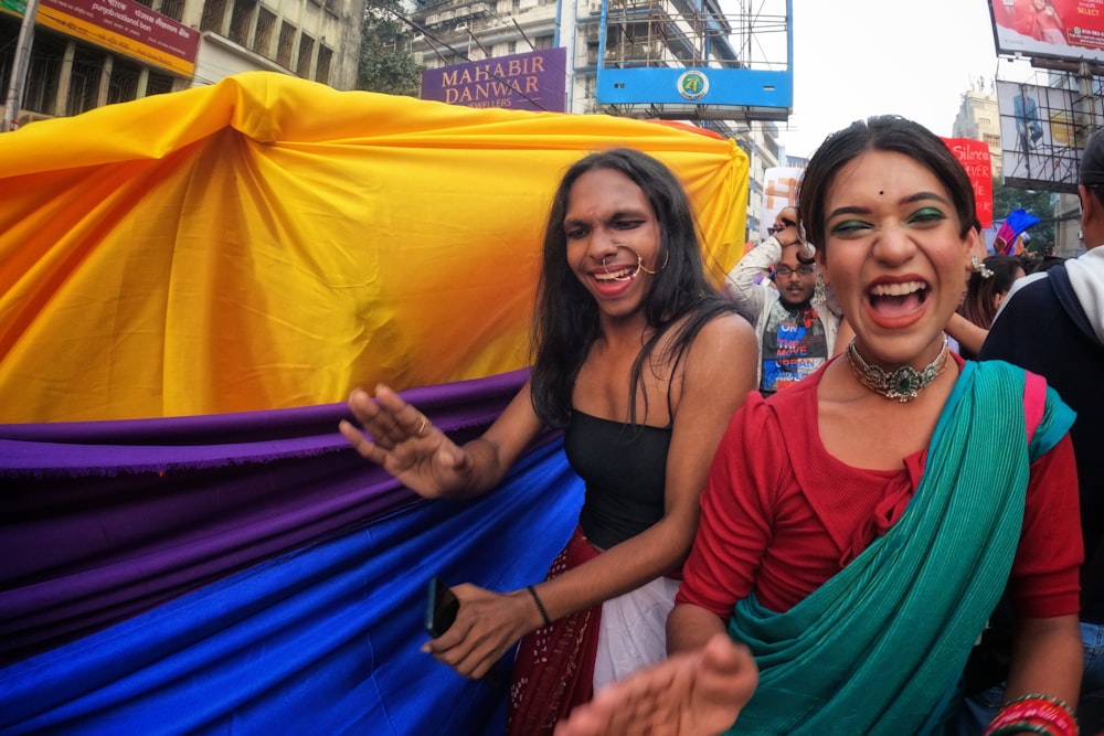 a group of women standing next to each other on a street