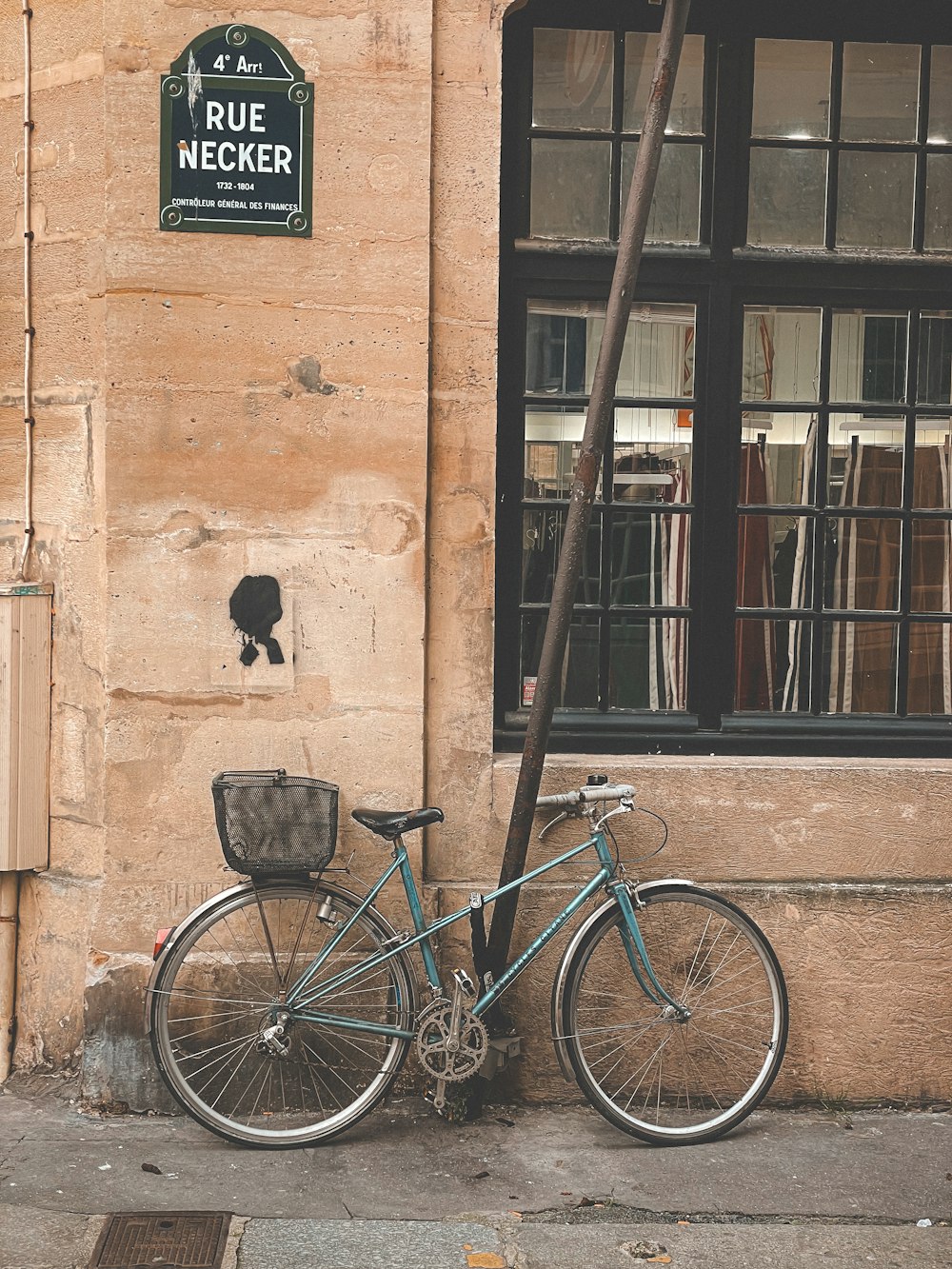 a blue bike parked next to a building