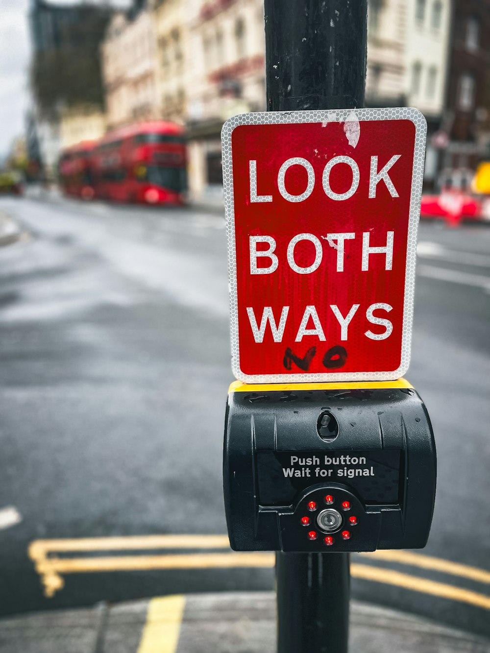 a red sign that says look both ways