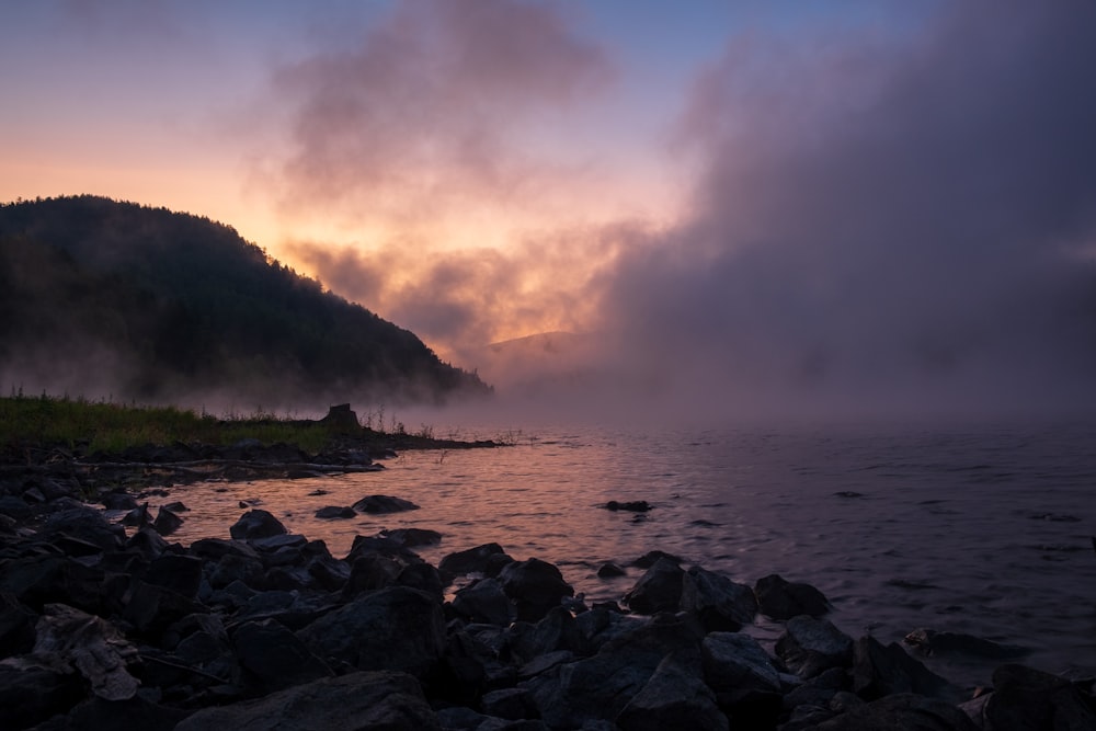 a body of water surrounded by rocks and trees