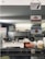 A rustic kitchen or diner environment features hanging signs, including those for Coca-Cola, pizza, and hamburgers. There is a vintage weighing scale on the counter, with a basket of snacks and some stacked plastic containers in view. A person is partially visible in the background near industrial kitchen equipment.