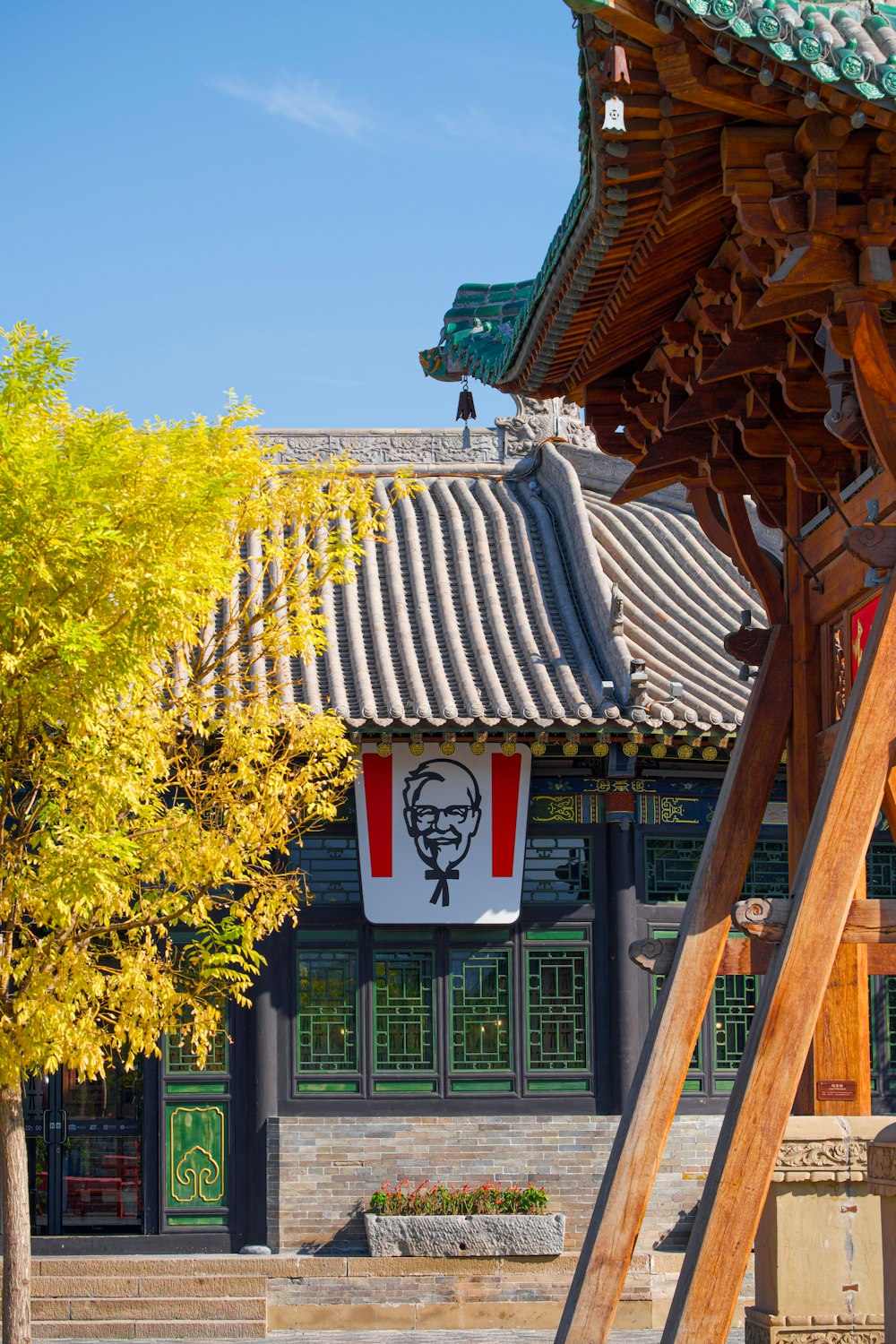 a tall wooden structure with a sign hanging from it's side