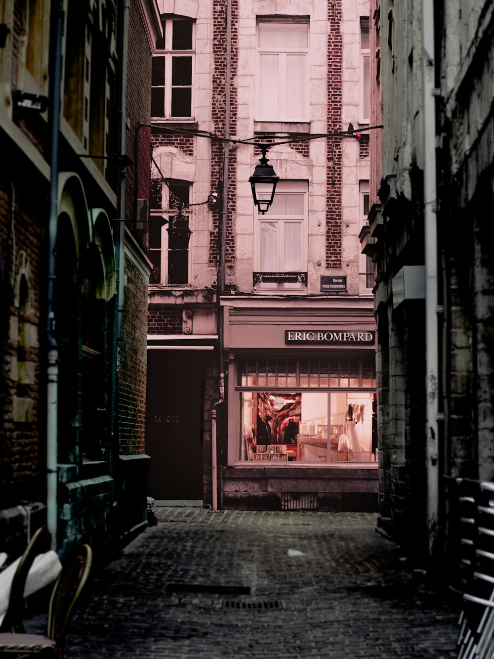 a narrow alley way with a store front