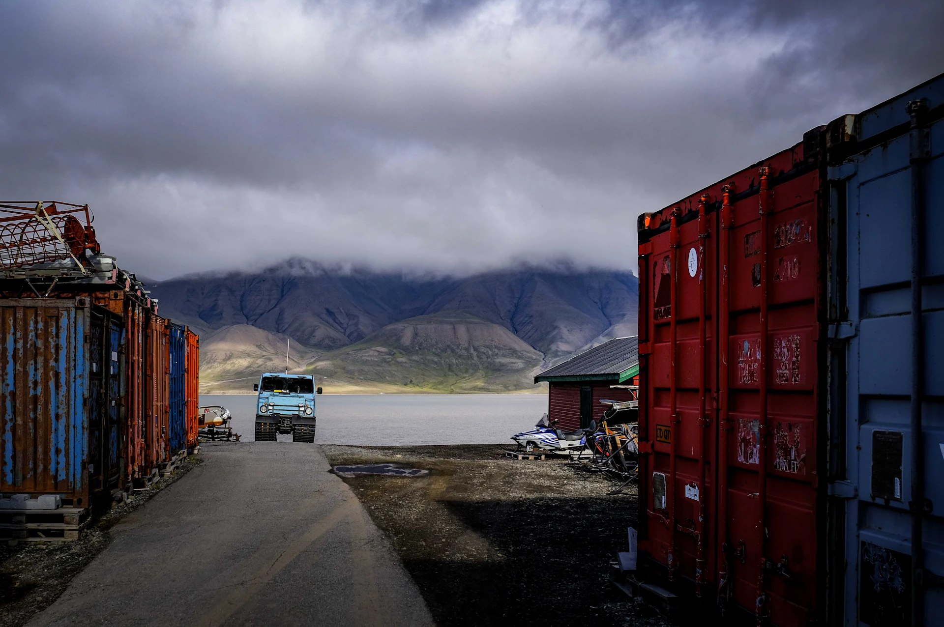 A rugged warehouse truck loaded with cargo equipment, ready for transport under a cloudy sky.