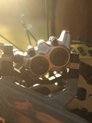 Close-up of a finely crafted slotted brake disc shining under workshop lights.