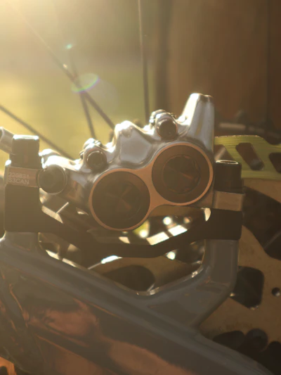 Close-up of a sleek brake disc and caliper gleaming under soft lighting.