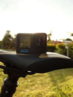 A high-resolution action camera mounted on a bike handlebar during a sunny ride
