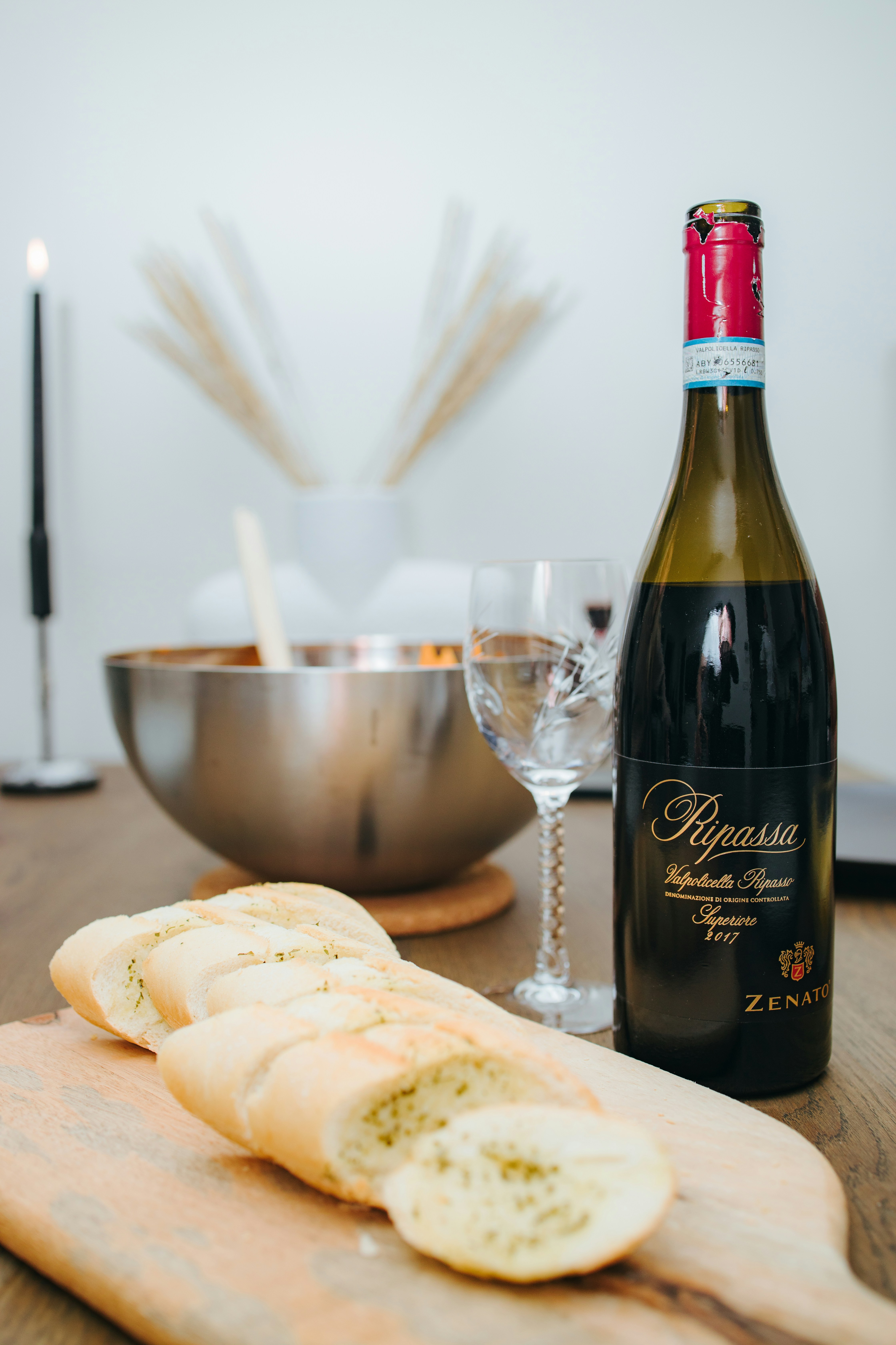 a bottle of wine and some bread on a table