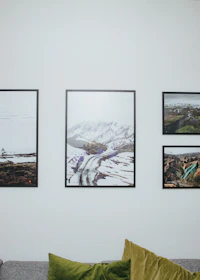 A close-up of a vibrant landscape print hanging on a cozy living room wall.