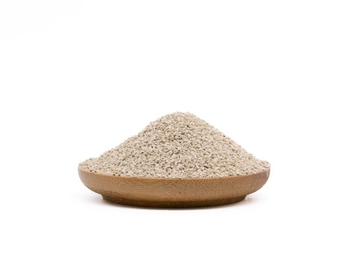 Close-up of nutritious animal feed grains in a wooden bowl.