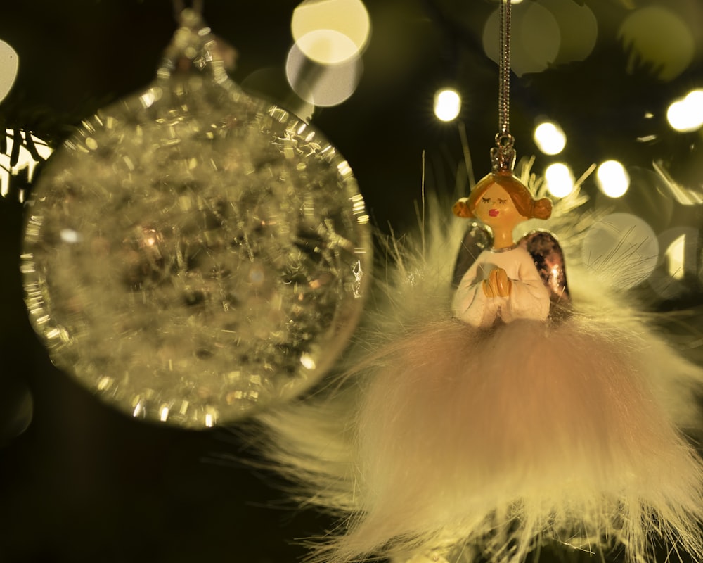 a glass ornament hanging from a christmas tree