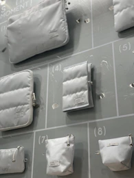 A collection of colorful maternity bags and accessories displayed on a clean white surface