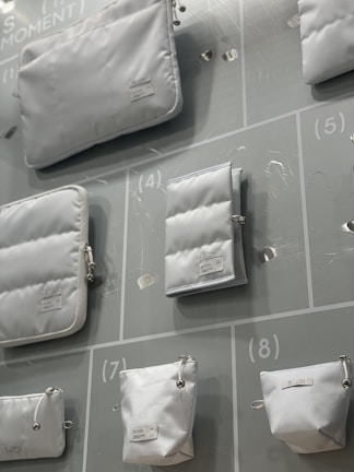 A variety of storage bags in different colors and sizes arranged on a clean white background.