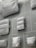 Various white pouches and bags of different sizes are displayed on a light-colored background with numbered sections. Each bag has a minimalistic design with labels attached.
