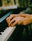 a close up of a person playing a piano