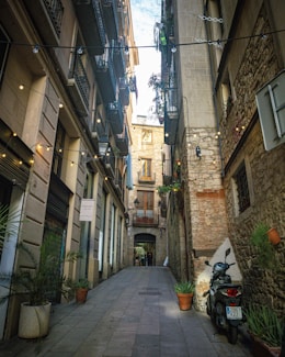a motorcycle parked on the side of a narrow street