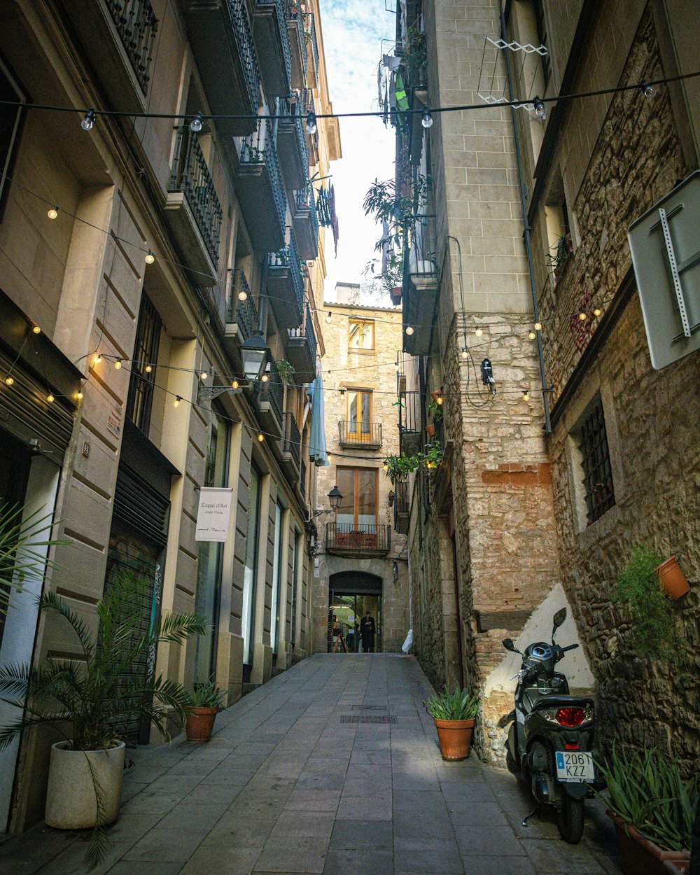 a motorcycle parked on the side of a narrow street