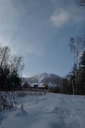 A beautifully landscaped mountain home in the Roaring Fork Valley with fresh snow on the ground.