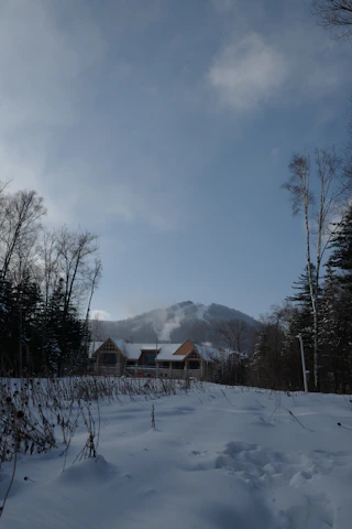 A beautifully landscaped mountain home in the Roaring Fork Valley with fresh snow on the ground.