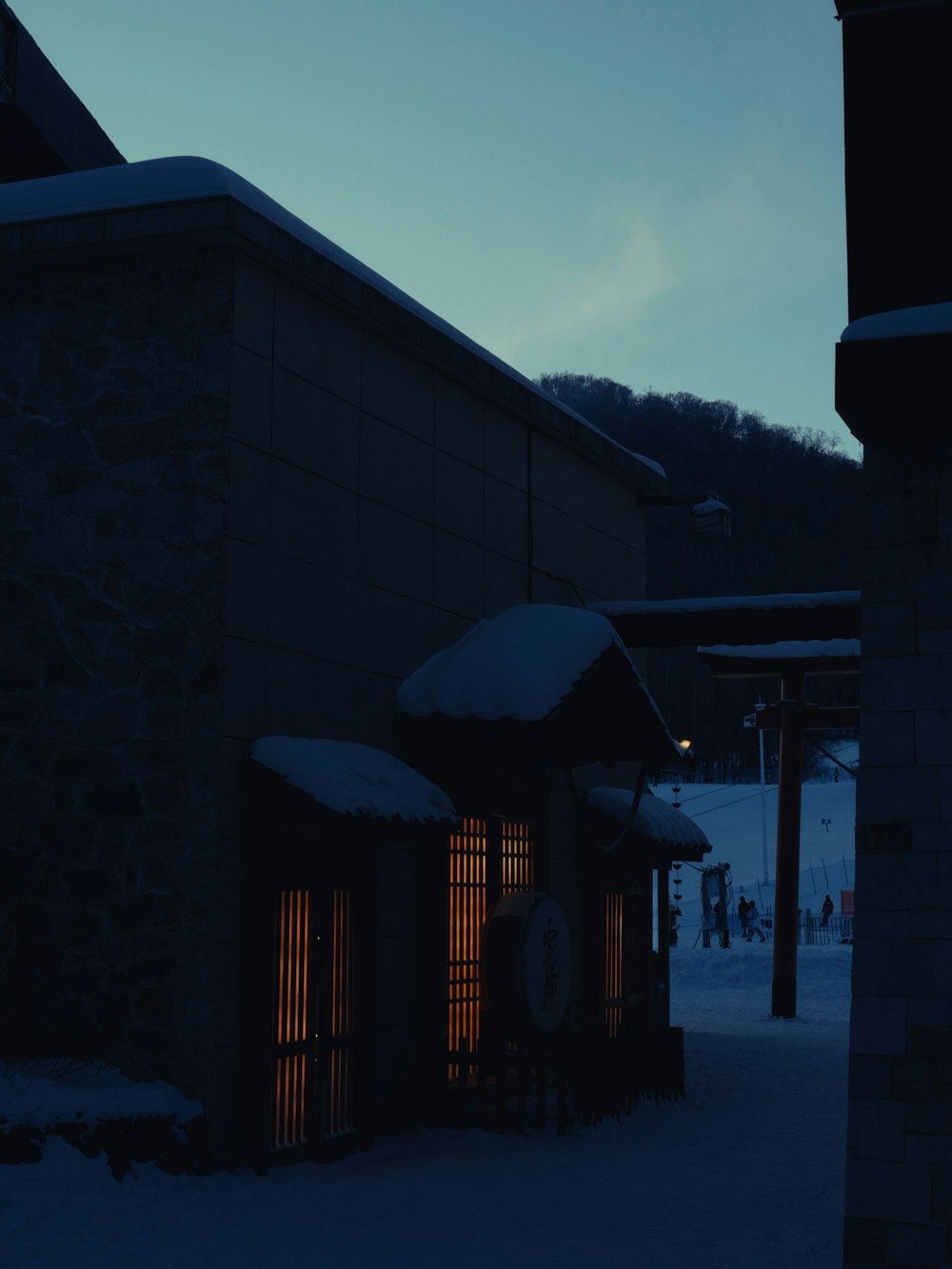 a building with a clock on the side of it in the snow