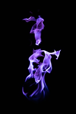 Mystical purple and gold flames swirling around an ethereal energy orb.