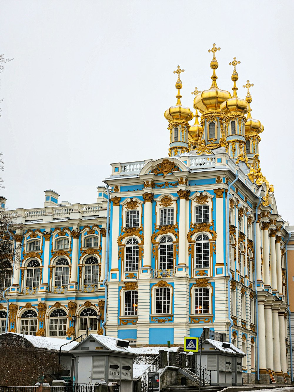 a large blue and white building with gold domes