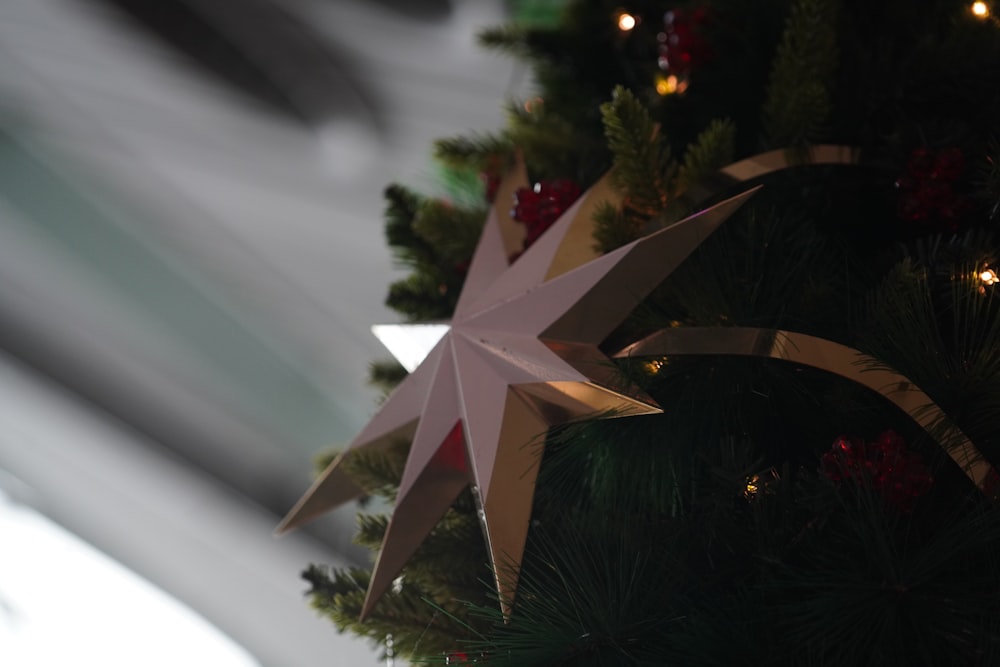 a close up of a christmas tree with a star decoration
