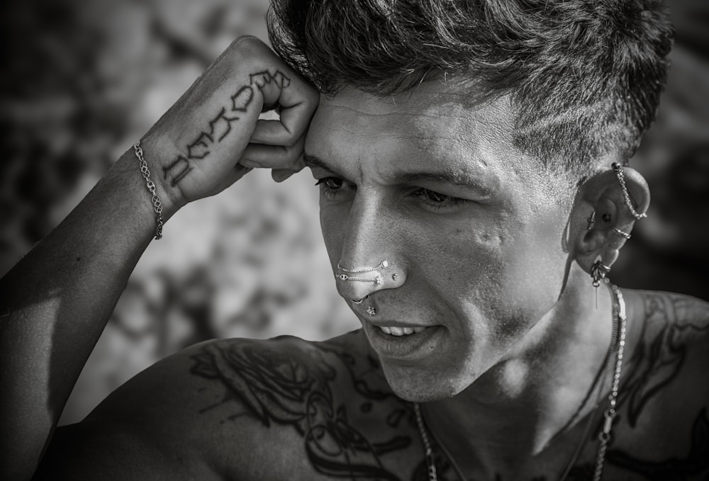 a man with tattoos on his face and nose