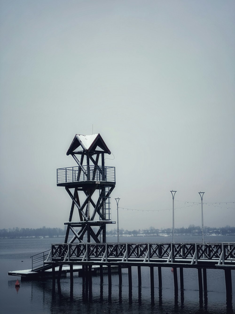 a pier with a life guard tower on top of it