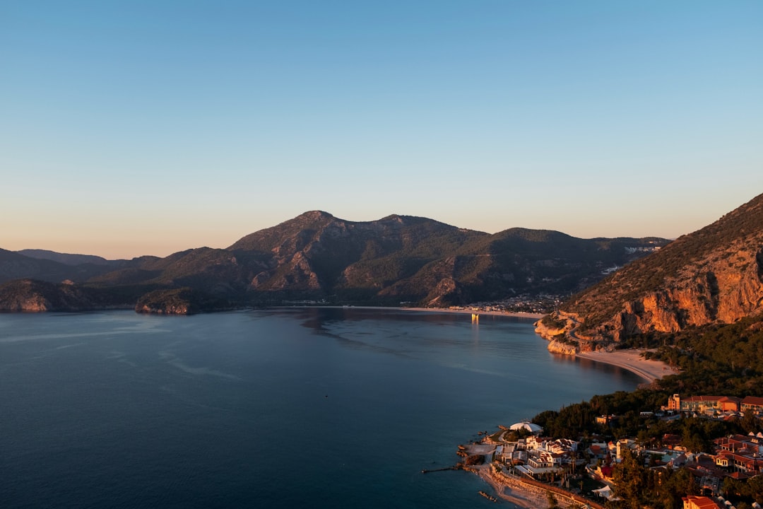 a large body of water surrounded by mountains,