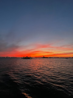 A vibrant sunset over Rio de Janeiro's iconic Christ the Redeemer statue.