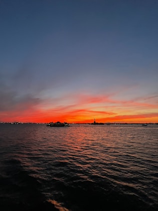 A vibrant sunset over Rio de Janeiro's iconic Christ the Redeemer statue