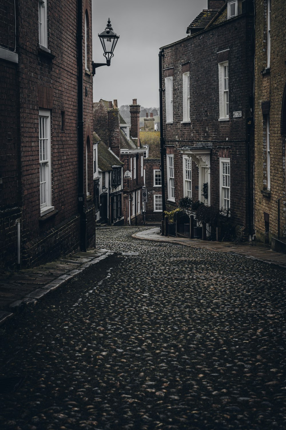 a cobblestone street lined with brick buildings