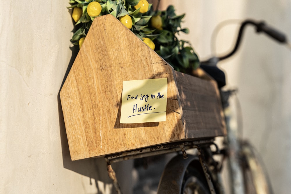 a wooden house with a note attached to it