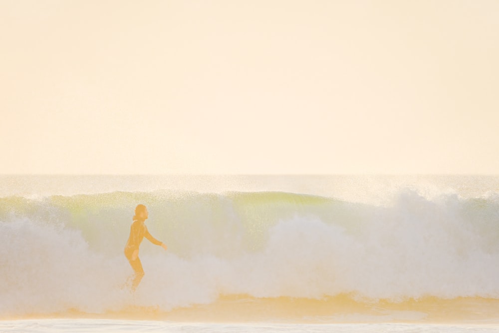 a man riding a wave on top of a surfboard